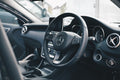 Black Mercedes-Benz car interior with steering wheel