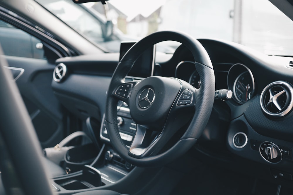 Black Mercedes-Benz car interior with steering wheel