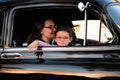 Girl and woman inside black car