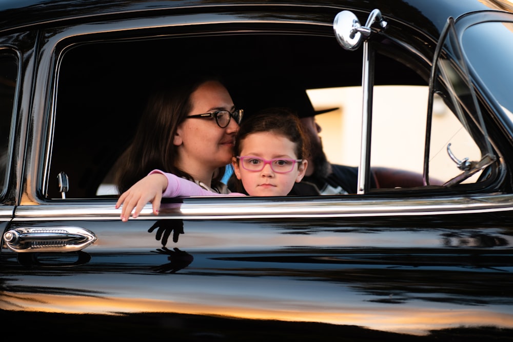 Children in back seat with window sun shade