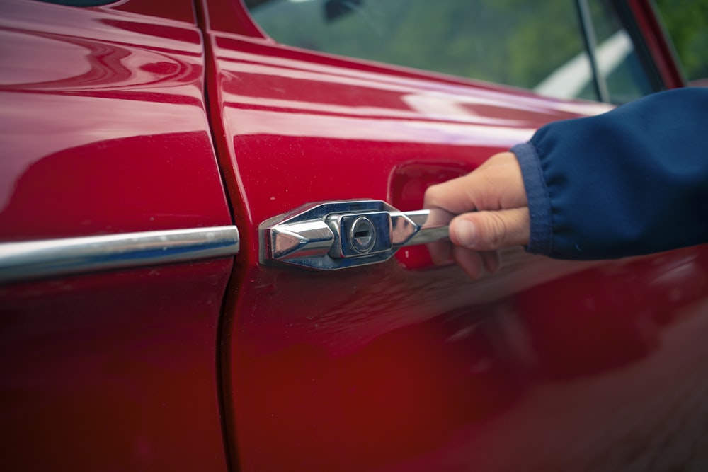 Person holding car door open