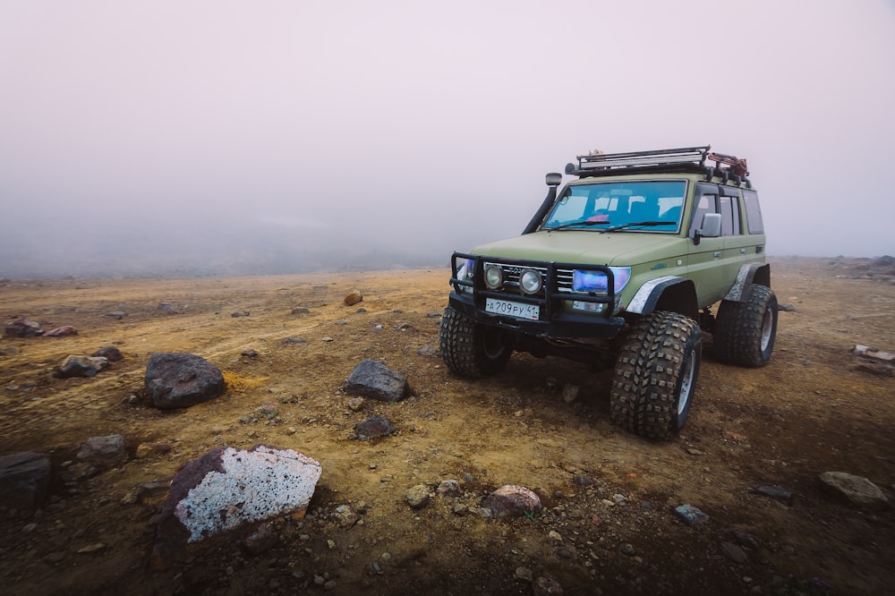 Green utility vehicle on brown soil off-road
