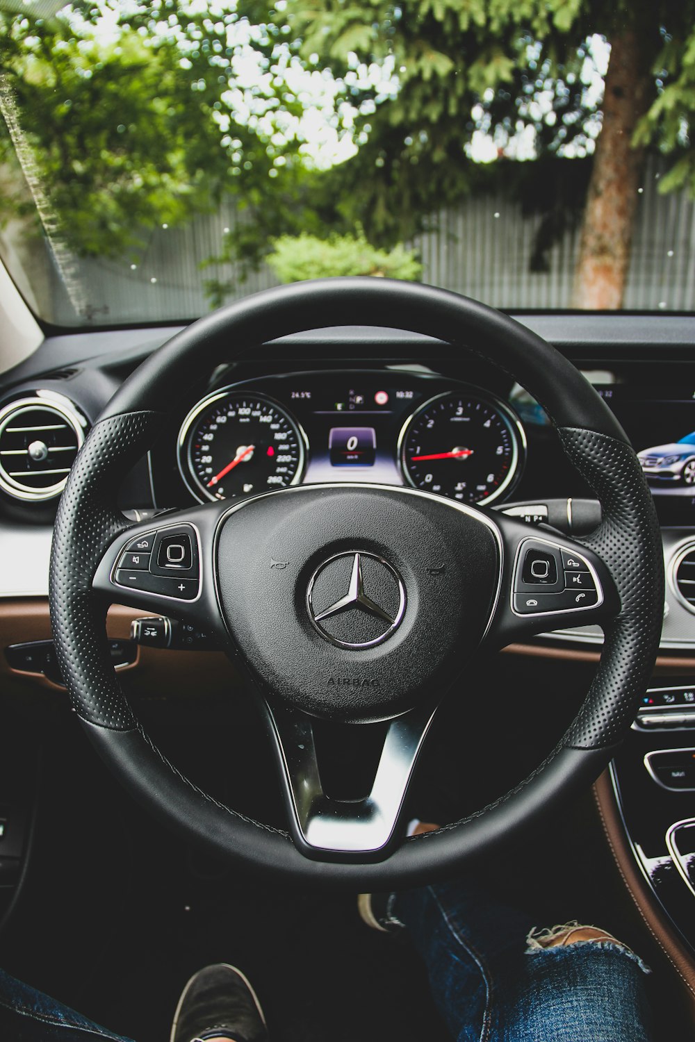Black Mercedes-Benz steering wheel close up