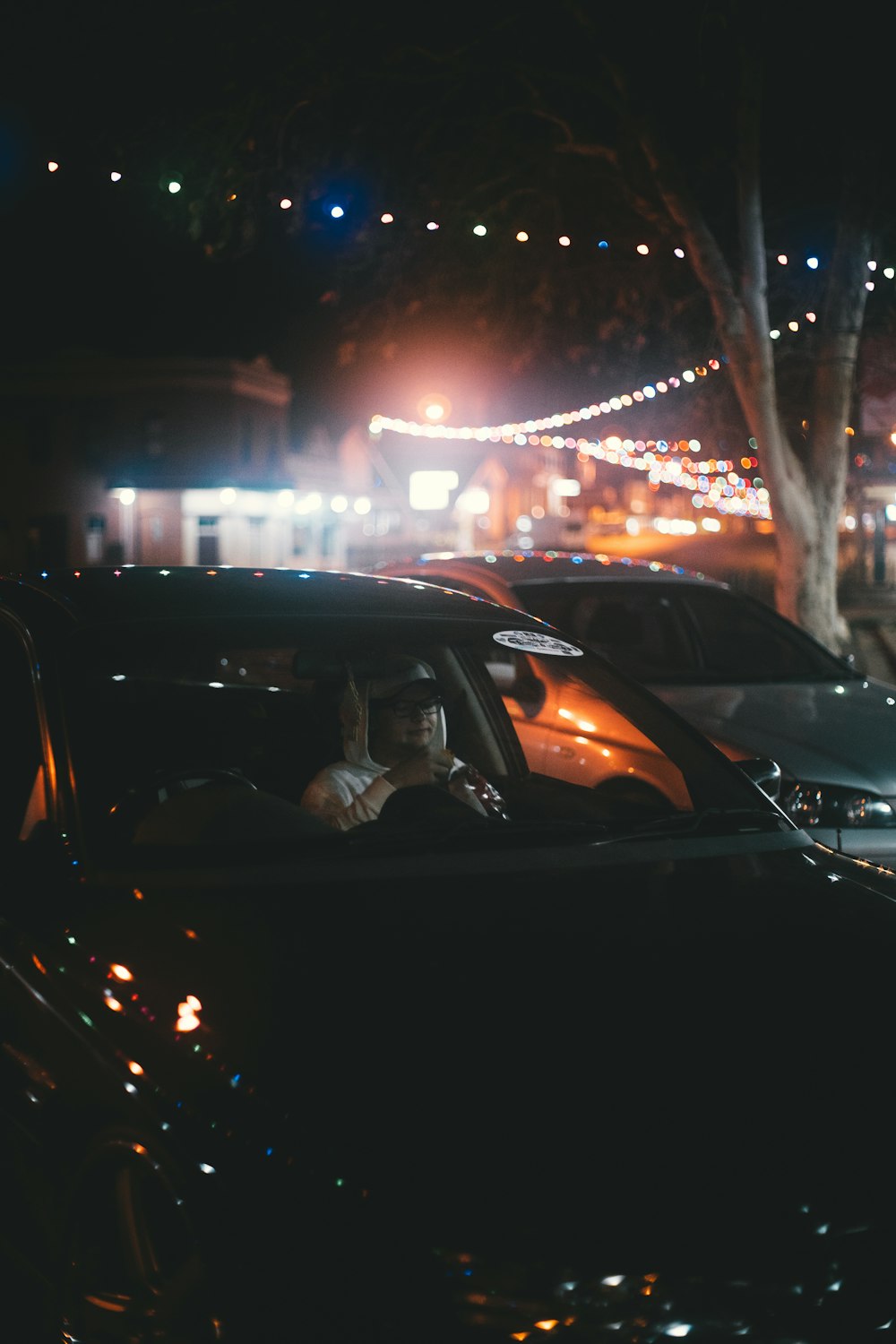 Person inside car during night with colorful lighting