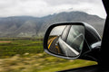 View of vehicle side mirror with vehicle reflected in the back