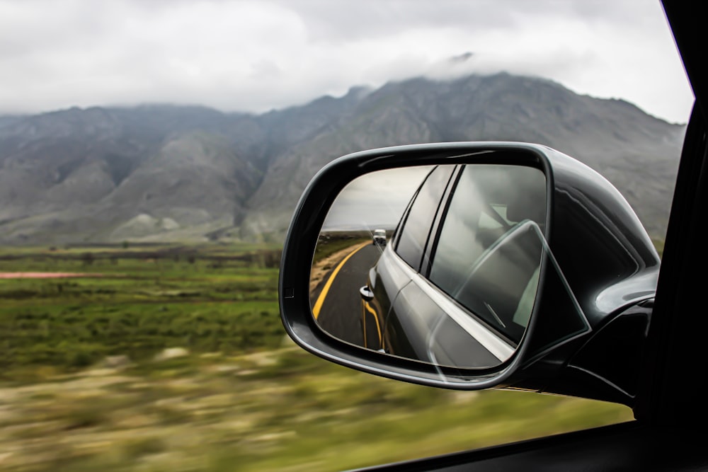 View of vehicle side mirror with vehicle reflected in the back
