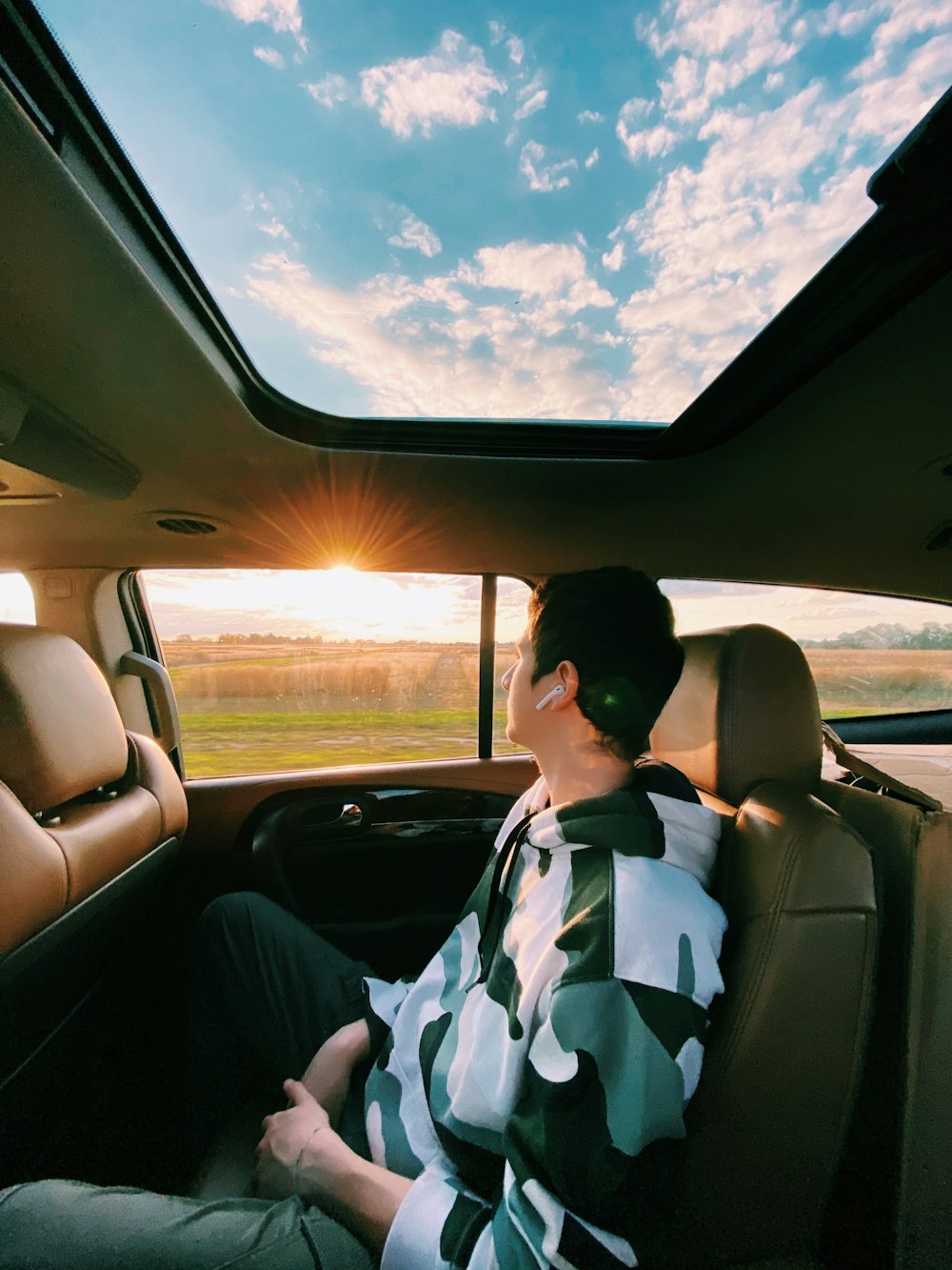Woman driving car using sun visor