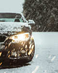 Black car on snow covered road