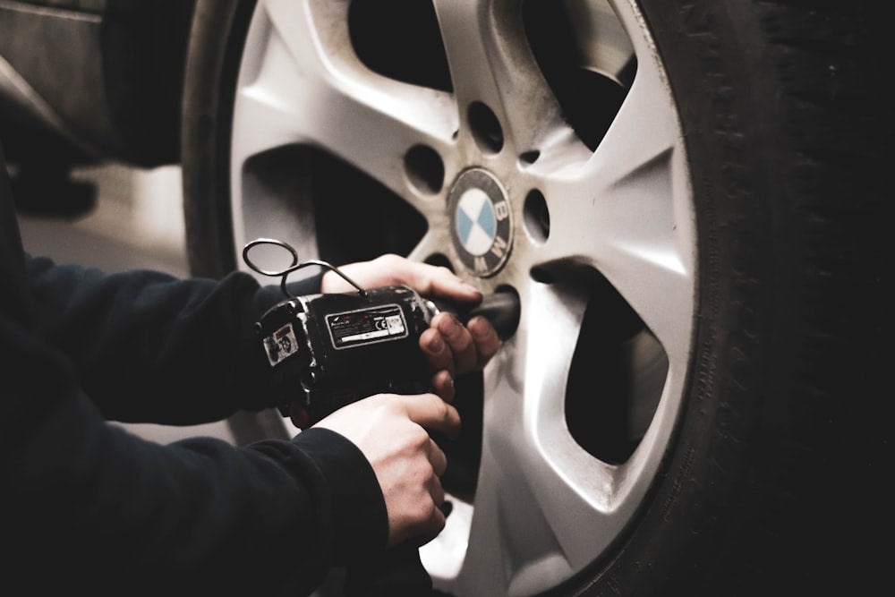 Person checking tire pressure with smartphone app