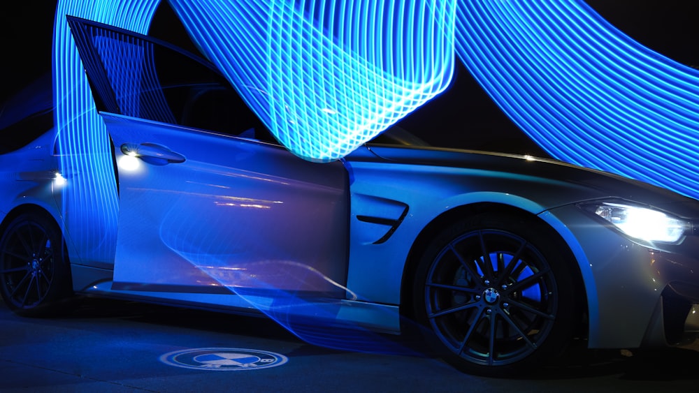 Blue car with illuminated wheel puddle light