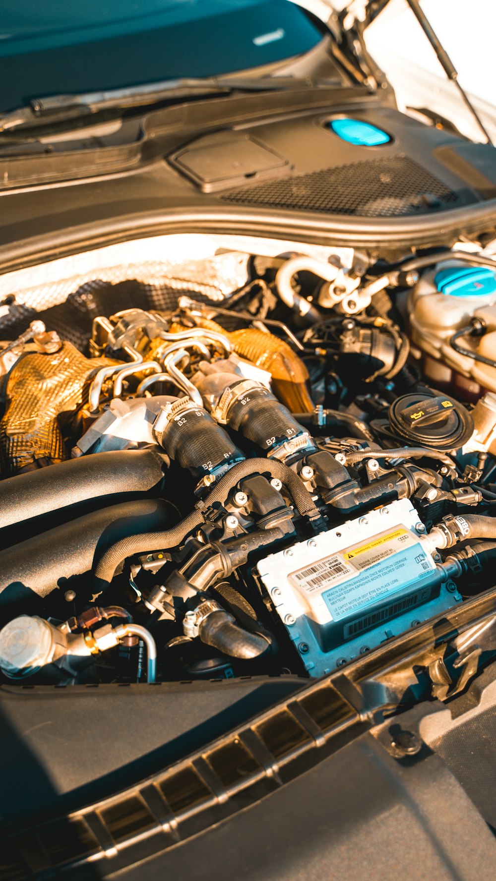 Close up of a car engine with hood open