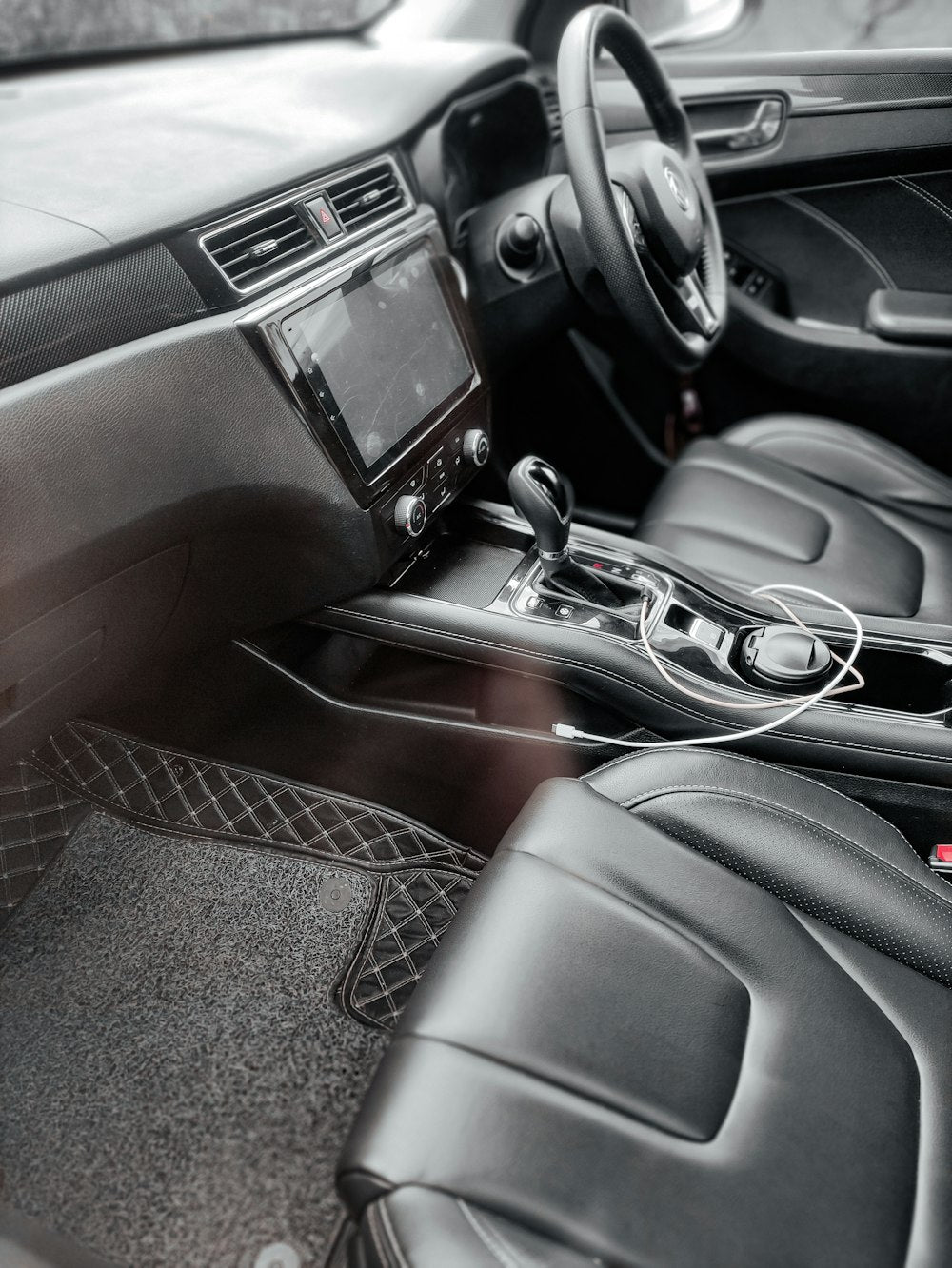 Car interior with black leather seats and floor