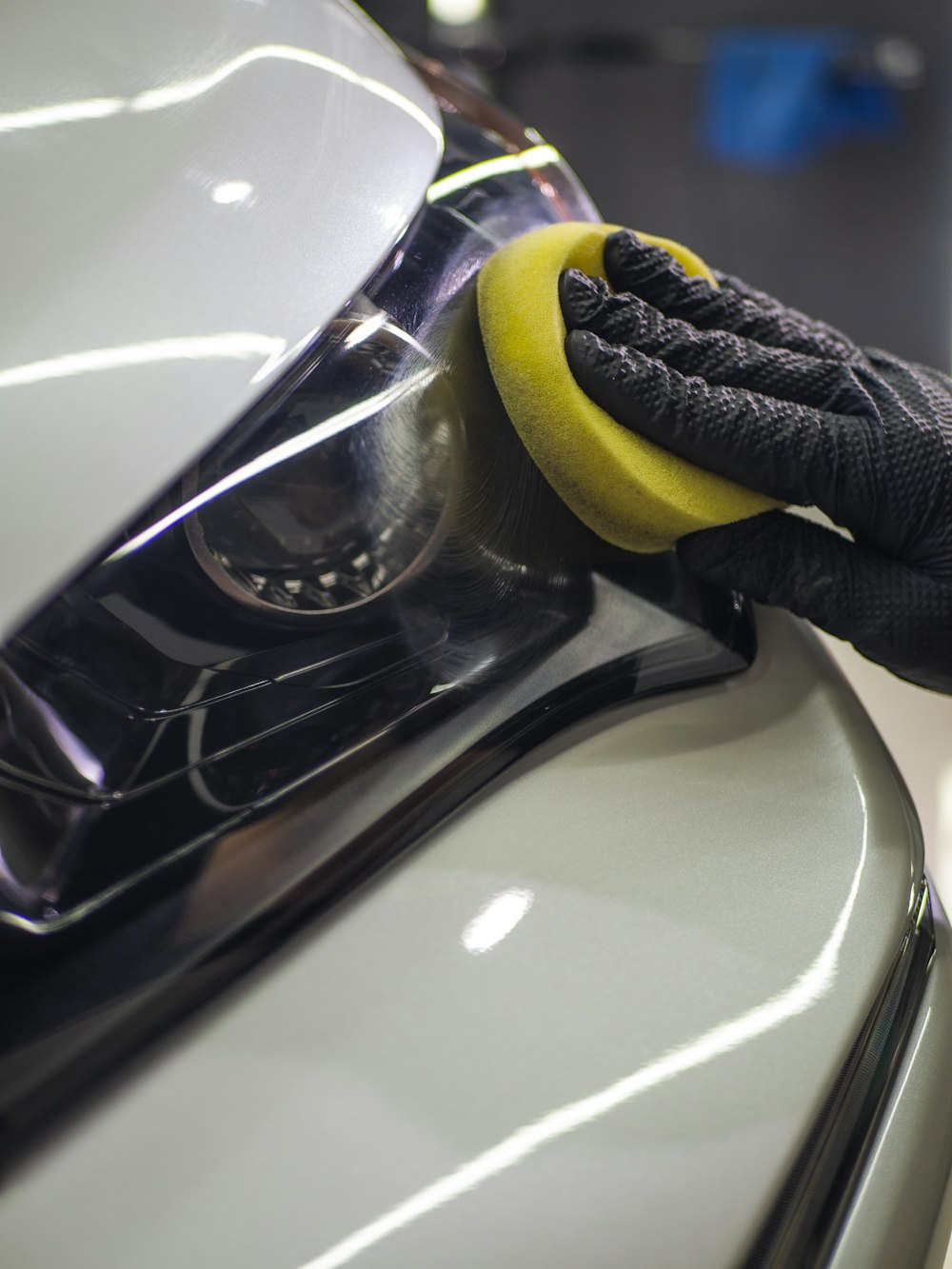 Person applying polish compound to car