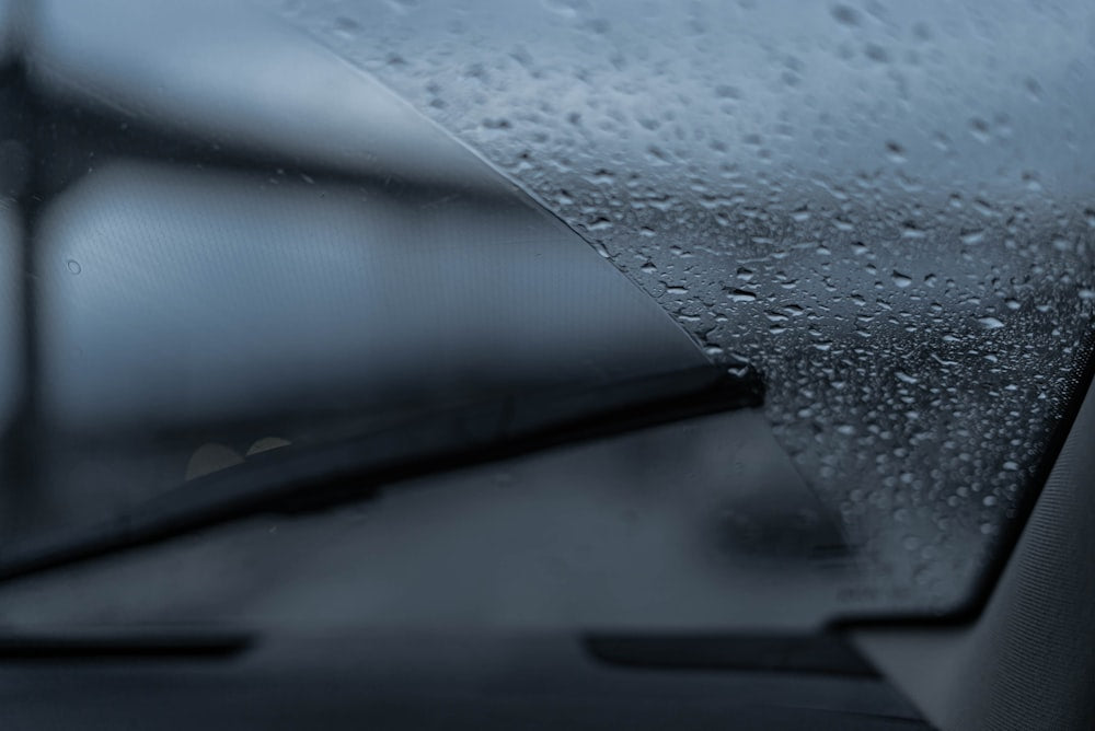 Rain drops on car windshield with wipers