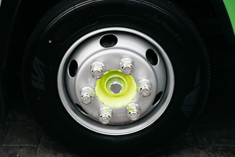 Close up of tire on green car with wheel lock