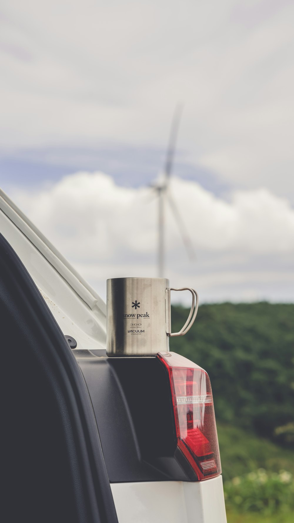 Hot beverage cup on car trunk