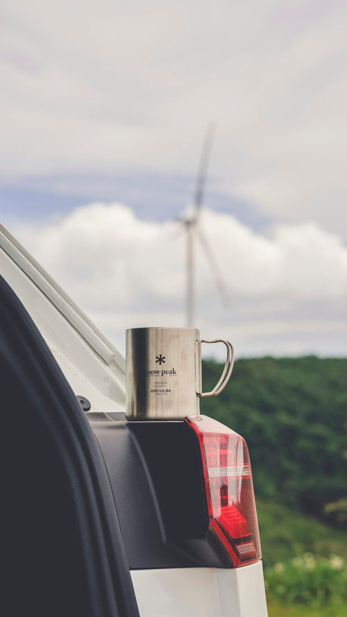 Hot beverage cup on car trunk