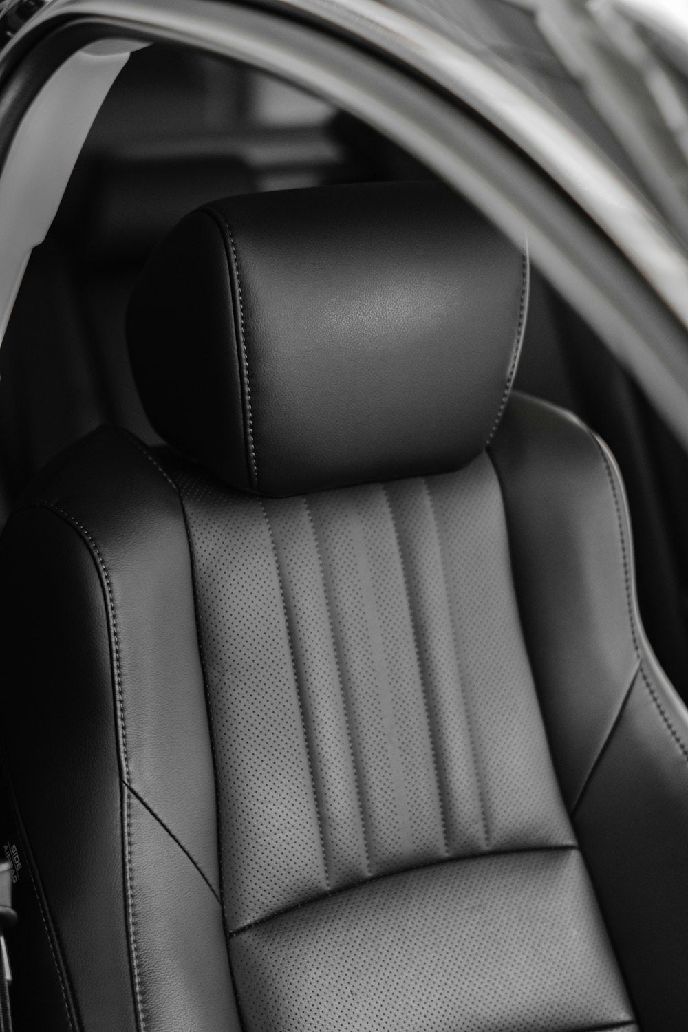 Black leather car seat close up