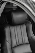 Black leather car seat with headrest