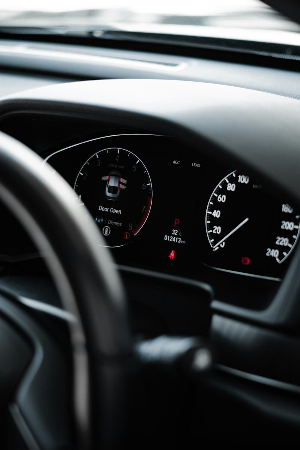 Car dashboard with black steering wheel