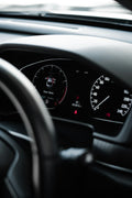 Car dashboard with black steering wheel