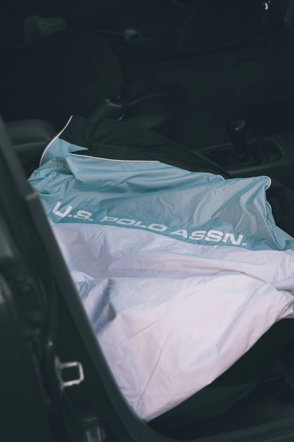 Open car trunk with bag inside