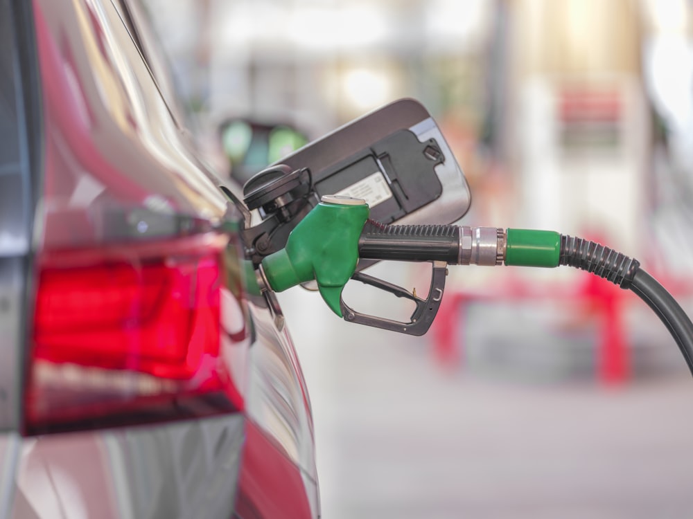 Gas pump connected to car at station