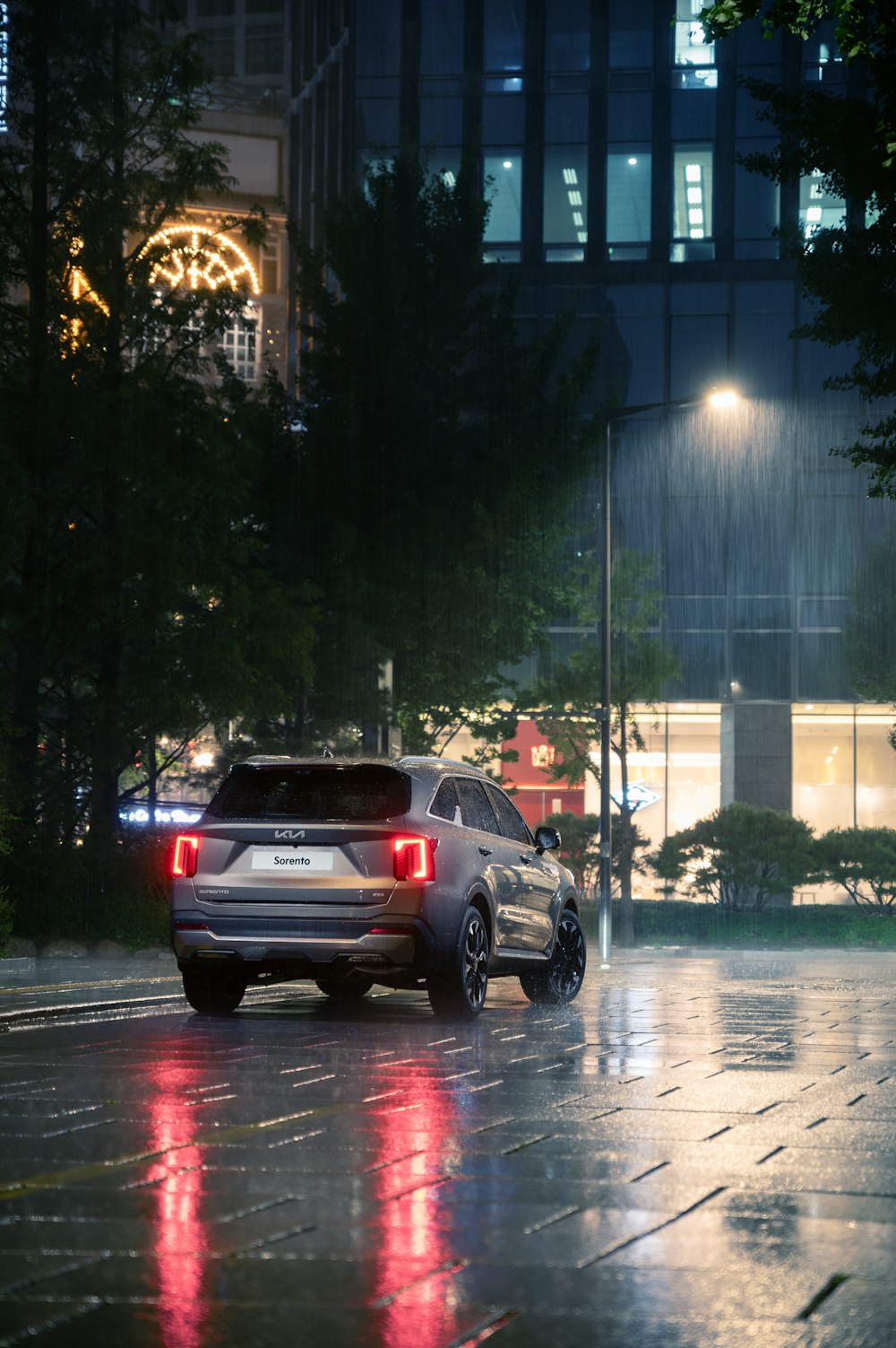 Car driving down the street in the rain