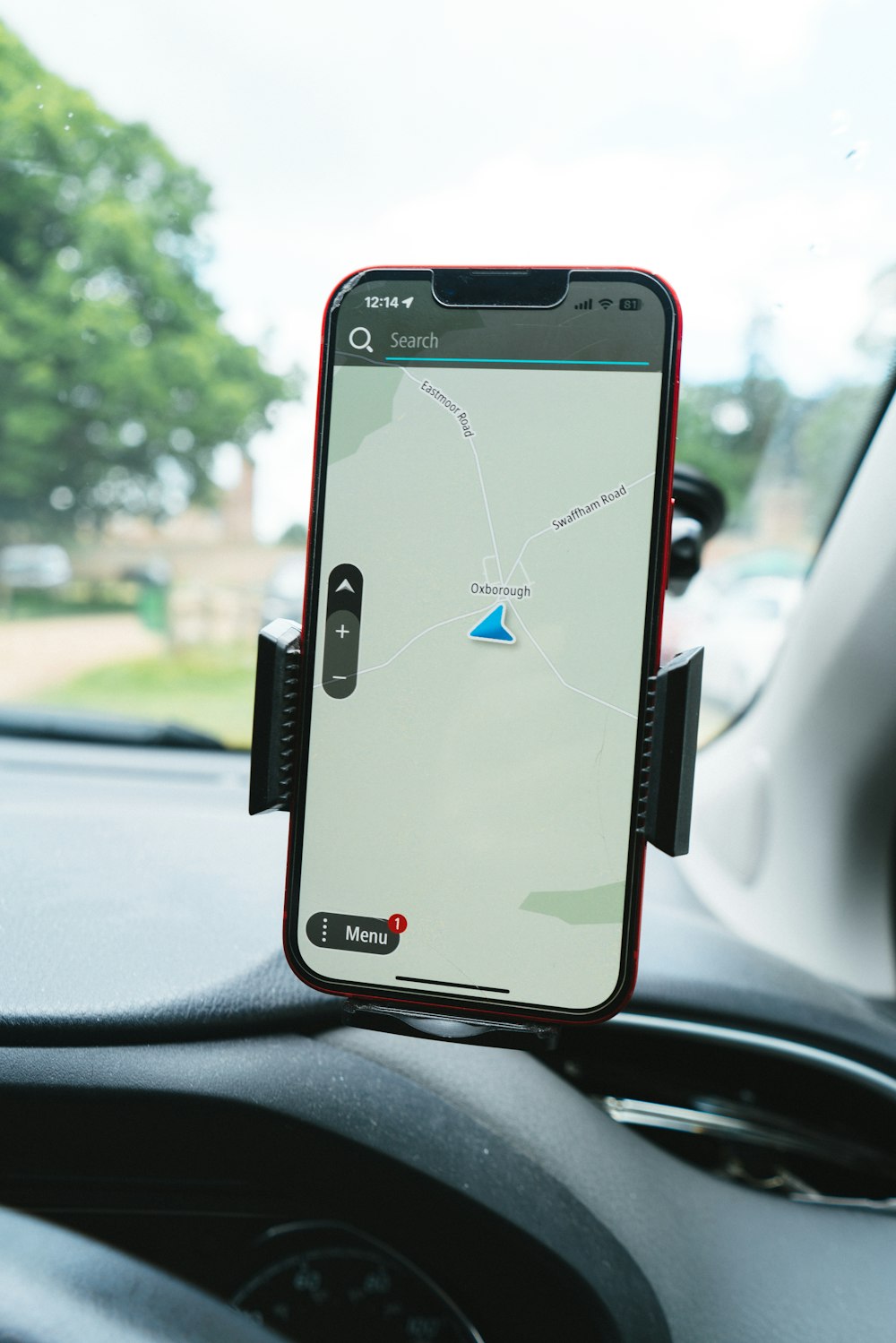 Cell phone mounted to the dashboard of a car