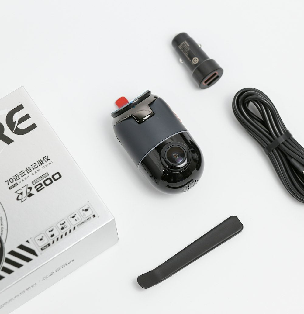 Dash cam and electronics on white surface