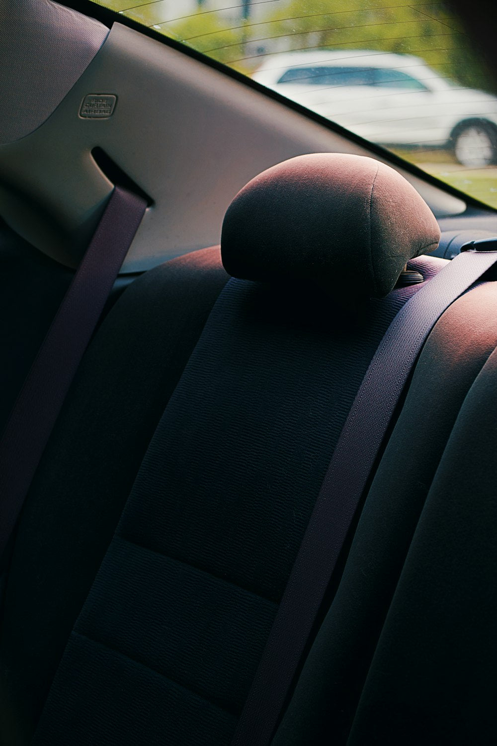 Dark back seat and headrest inside a car