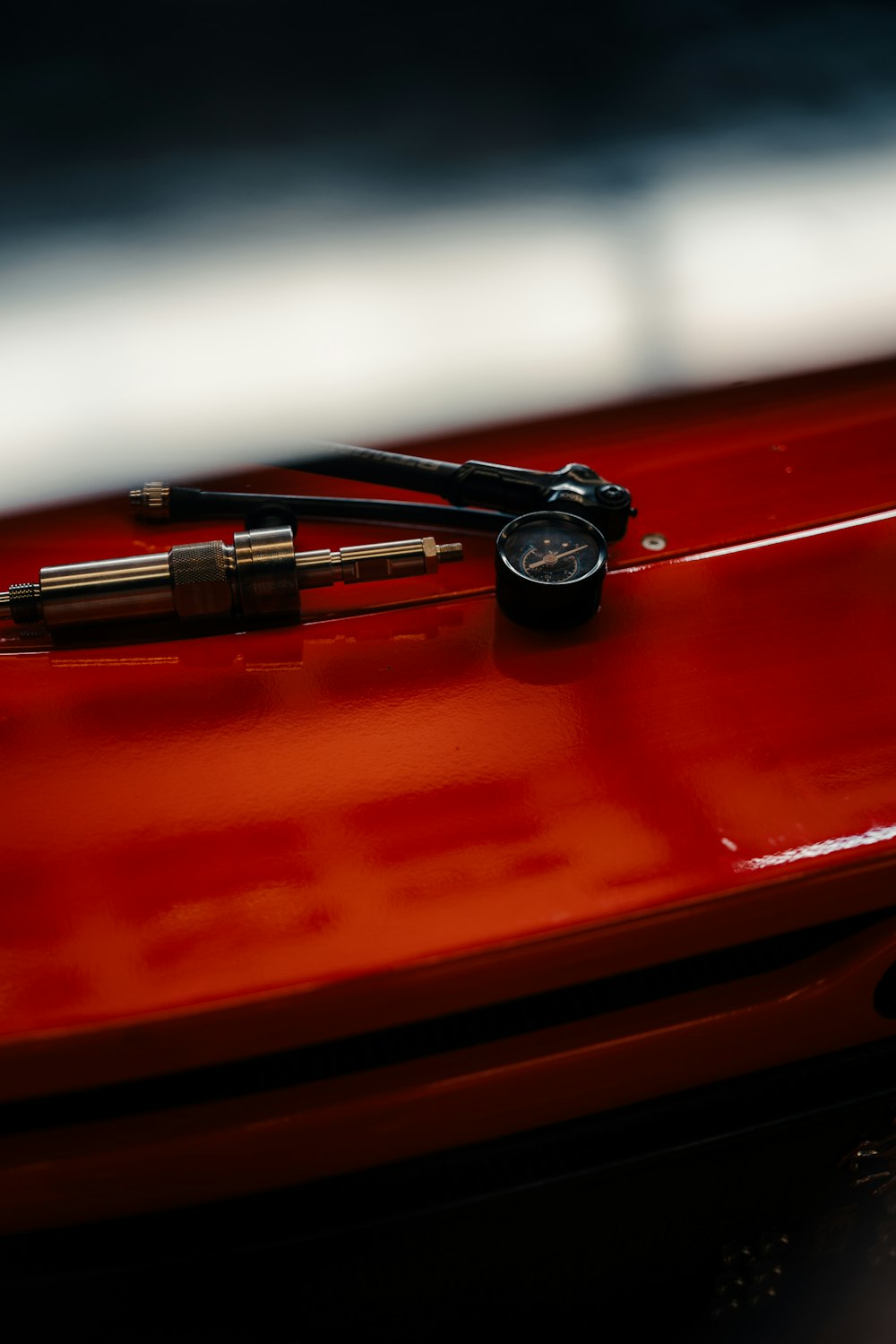 Digital tire pressure gauge on red surface