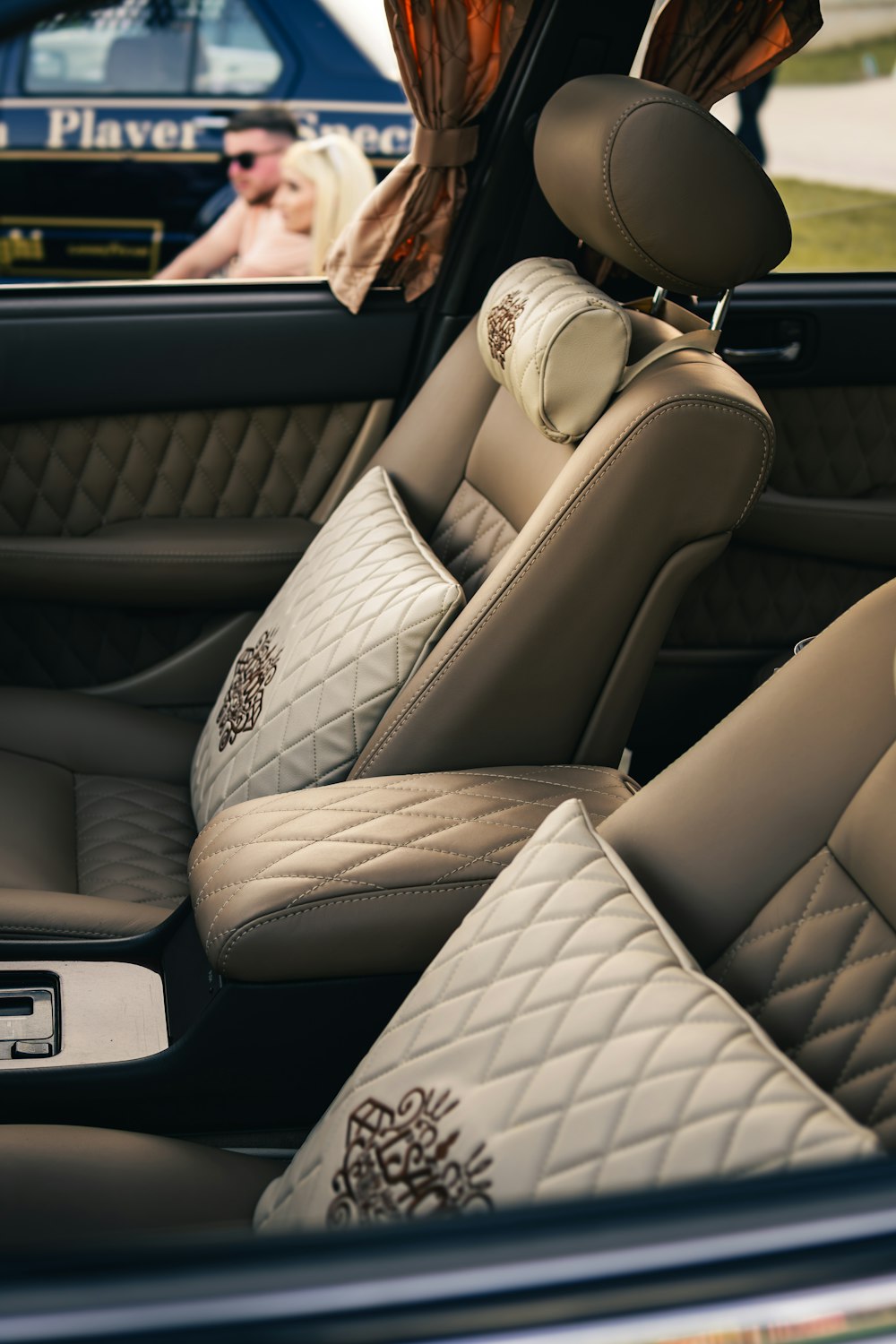 Luxury car interior with plush seats and pillows
