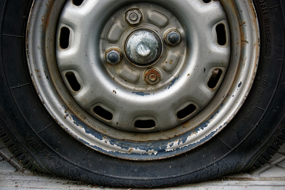 Close-up of worn car tire and rim