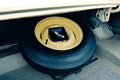 Spare tire and jack in car trunk