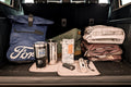 Car trunk organized with bags and travel accessories