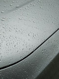 Water droplets on metallic gray car hood