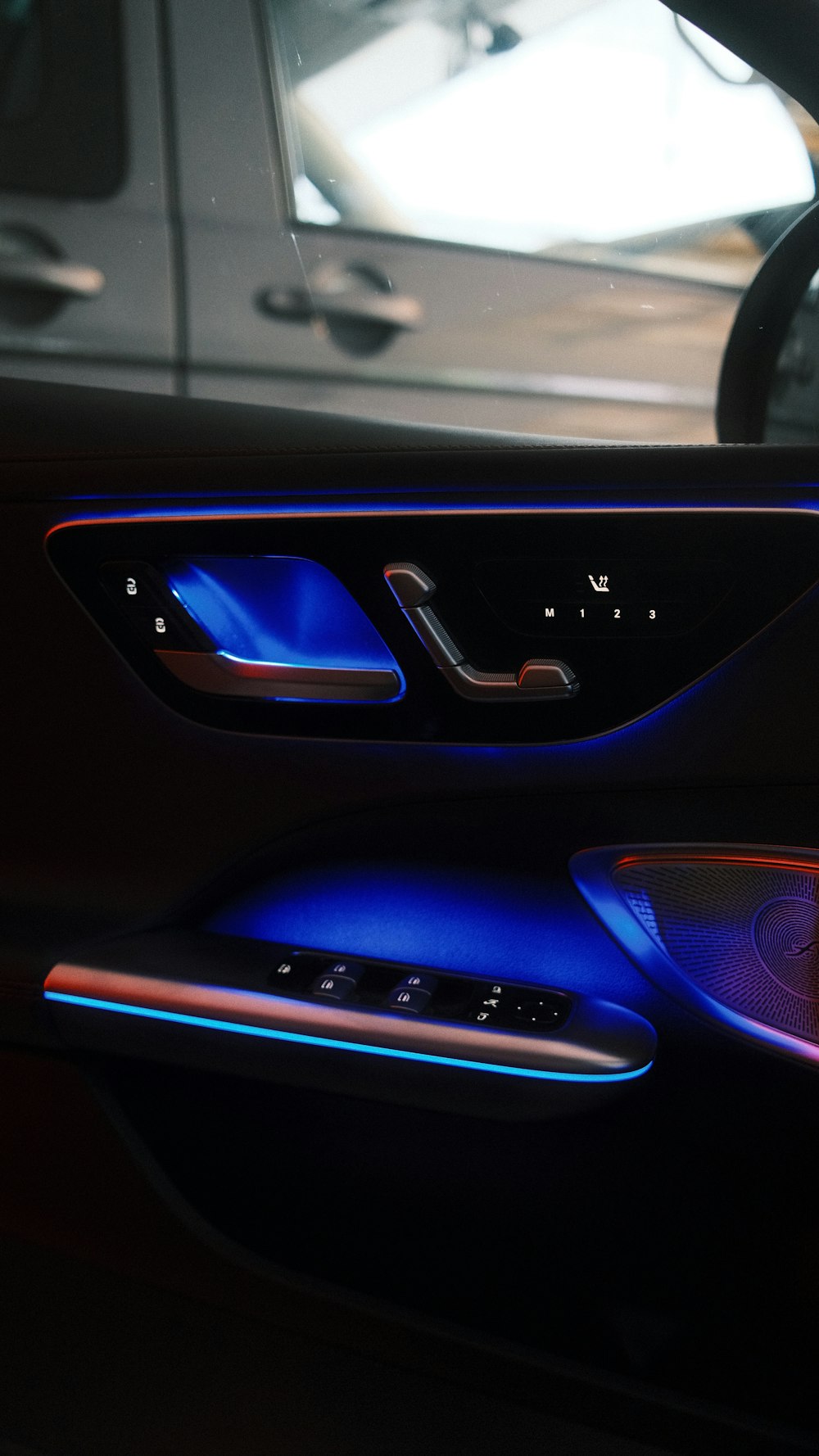 Car door interior with blue ambient lighting